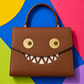 GOOUNIES brown statement bag colorful flat lay