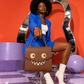 Model carrying the GOOUNIES brown statement bag