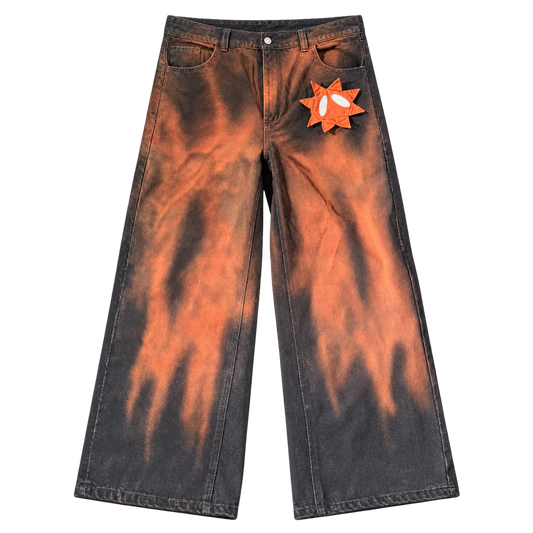 Front view of GOOUNIES orange and charcoal wide-leg jeans with an orange face patch